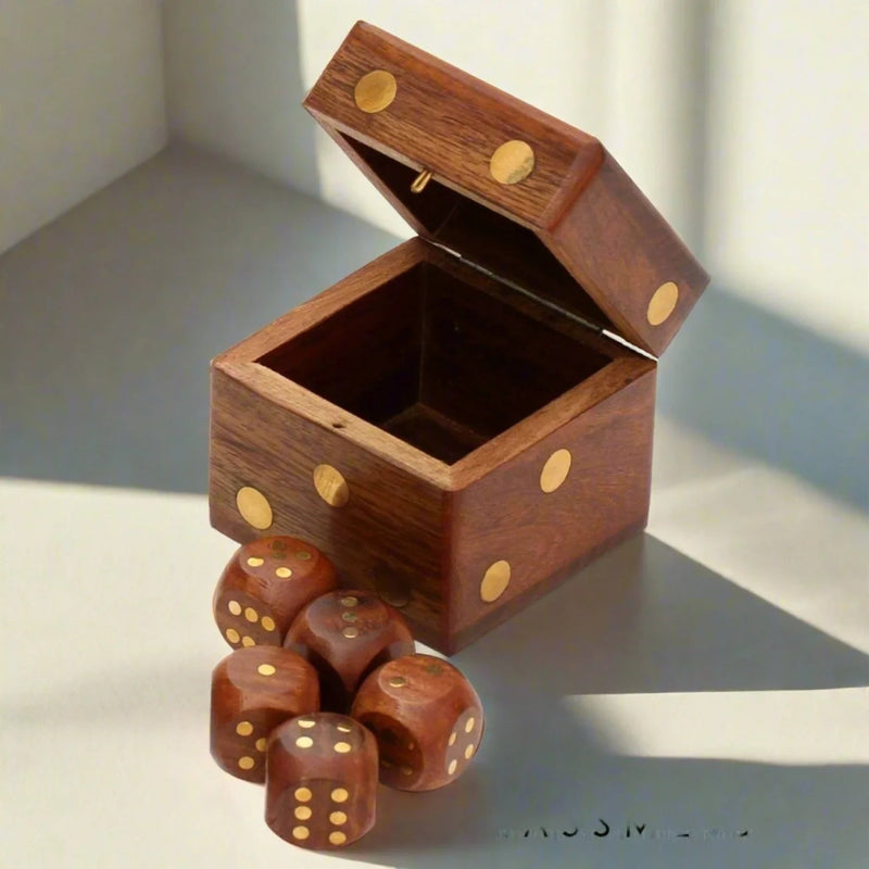Open wooden dice box with brass-coloured dots and matching wooden dice