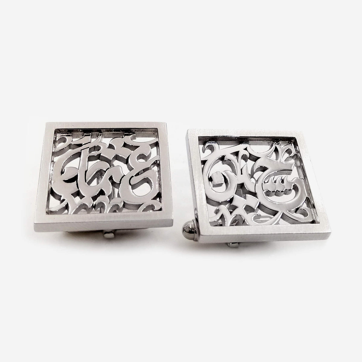 Square framed silver cufflinks with intricate Arabic calligraphy.