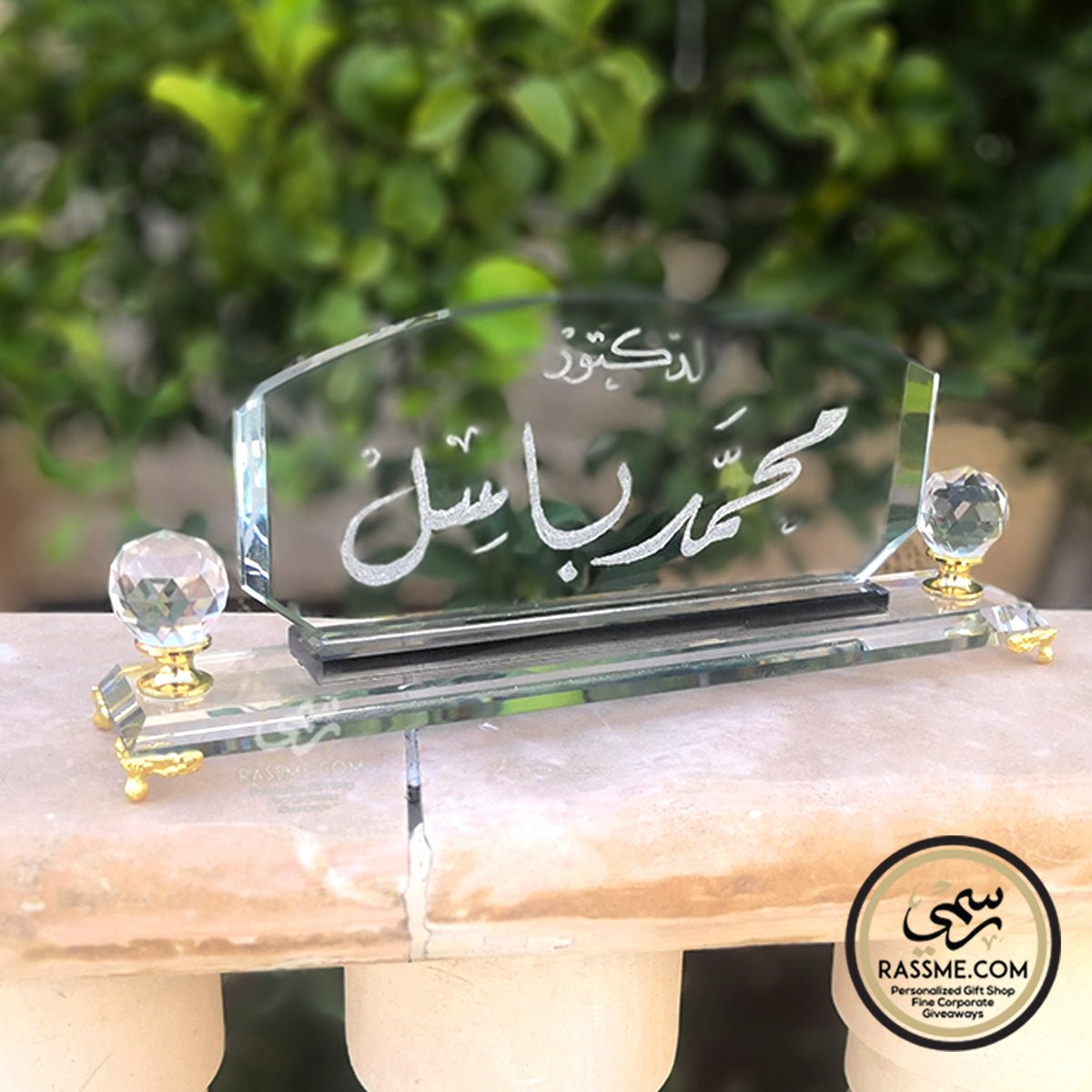Clear crystal desk name sign with golden stands and Arabic calligraphy