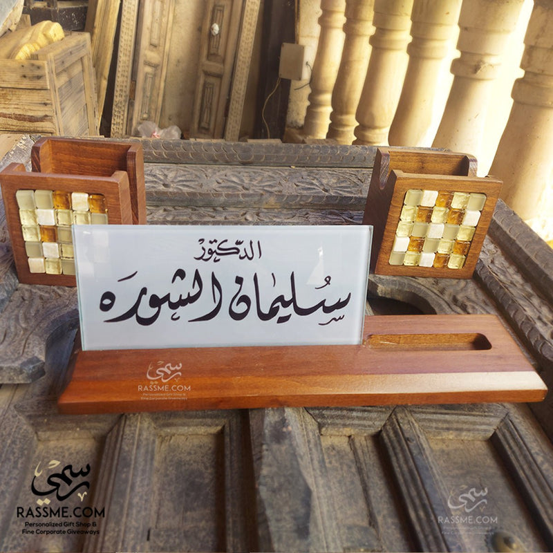 Wooden desk name sign with a glass calligraphy panel and matching card holders